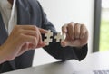 A man uses both hands to try to connect the two jigsaw puzzles together. symbol of association and connection. support and help Royalty Free Stock Photo