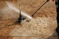 A man uses an electric pressure washer for a pressure washer. Cleaning city fountains in autumn. Workers remove the dirt that has Royalty Free Stock Photo