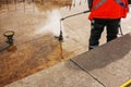 A man uses an electric pressure washer for a pressure washer. Cleaning city fountains in autumn. Workers remove the dirt that has Royalty Free Stock Photo