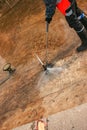 A man uses an electric pressure washer for a pressure washer. Cleaning city fountains in autumn. Workers remove the dirt that has Royalty Free Stock Photo