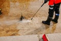 A man uses an electric pressure washer for a pressure washer. Cleaning city fountains in autumn. Workers remove the dirt that has Royalty Free Stock Photo