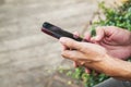 Man uses his Mobile Phone outdoor, close up Royalty Free Stock Photo