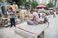 Man uses a mobile while the Panjiayuan Antique Market, Beijing