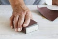 Man uses a sandpaper to restore wooden surface