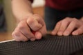 A man uses a special stencil and stylus to write a letter in braille. Royalty Free Stock Photo