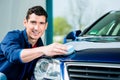 Man using an absorbent towel for drying the surface of a car Royalty Free Stock Photo