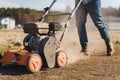 Man using aerator machine to scarification and aeration of lawn or meadow