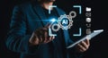 Man using AI on tablet with gears data cloud and virtual reality applications integration Royalty Free Stock Photo