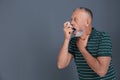 Man using asthma inhaler on color background with space Royalty Free Stock Photo