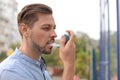 Man using asthma inhaler. Health care Royalty Free Stock Photo