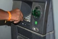 Man using ATM machine to withdraw his money. closeup of hand entering PIN or pass code on ATM machine keypad,security code on Royalty Free Stock Photo