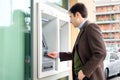 Man making a cash withdrawal from atm bancomat service