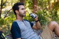 Man using binoculars while resting in the forest Royalty Free Stock Photo