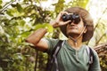 Man using binoculars watching birds in the jungle Royalty Free Stock Photo