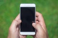 Man using blank screen smartphone in nature