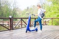 Man using blue electric scooter in the park