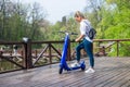 Man using blue electric scooter in the park