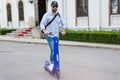 Man using blue electric scooter in the park