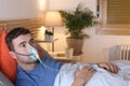 Man using breathing mask in bed Royalty Free Stock Photo