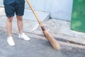 Man using broom sweep the street or floor garbage cleaning service concept city.Maintenance worker in park garden cleans the roads