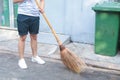 Man using broom sweep the street or floor garbage cleaning service concept city.Maintenance worker in park garden cleans the roads