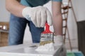 Man using brush to paint bekvam with white dye indoors, closeup Royalty Free Stock Photo