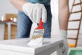 Man using brush to paint bekvam with white dye indoors, closeup Royalty Free Stock Photo