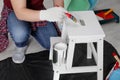 Man using brush to paint bekvam with white dye indoors, closeup Royalty Free Stock Photo