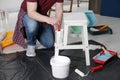 Man using brush to paint bekvam with white dye indoors, closeup Royalty Free Stock Photo