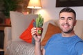 Man using a cactus to absorb radiation at home Royalty Free Stock Photo