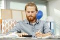 man using calculator at desk