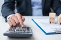 Man using calculator during signing home contract documents. Contract agreement, real estate,  buy and sale and insurance concepts Royalty Free Stock Photo