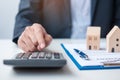 Man using calculator during signing home contract documents. Contract agreement, real estate,  buy and sale and insurance concepts Royalty Free Stock Photo