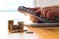 Man using calculator to count money savings and living costs.