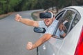Man using car driving video simulation and wearing virtual reality glasses