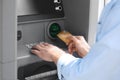 Man using cash machine for money withdrawal outdoors Royalty Free Stock Photo