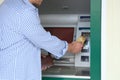 Man using cash machine for money withdrawal outdoors Royalty Free Stock Photo