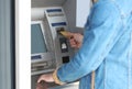 Man using cash machine for money withdrawal outdoors Royalty Free Stock Photo