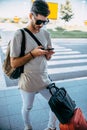 Man using cellphone while waiting cab from airport Royalty Free Stock Photo