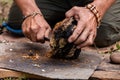 Man using chaga mushroom to keep fire alive