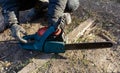 A man is using a chainsaw to cut a log Royalty Free Stock Photo