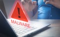 Man using computer laptop with caution warning sing for notification error and virus detection spyware, Internet network security Royalty Free Stock Photo