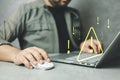 Man using computer laptop with triangle caution warning sign for notification error Royalty Free Stock Photo