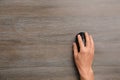 Man using computer mouse on wooden table, top view Royalty Free Stock Photo