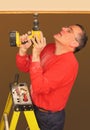 Man using cordless electric drill