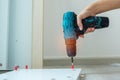 man using a cordless screwdriver assembling furniture at home, Carpenter working with electric screwdriver on the work Royalty Free Stock Photo