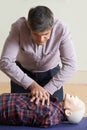 Man Using CPR Technique On Dummy In First Aid Class Royalty Free Stock Photo