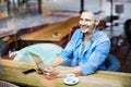 Man using digital tablet at cafe Royalty Free Stock Photo