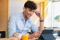 Man using digital tablet at coffee bar