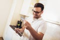 Man using digital tablet and credit card in kitchen at home Royalty Free Stock Photo